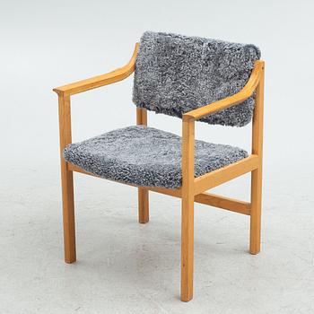 Karl Erik Ekselius, an oak armchair with sheepskin upholstery, JOC, second part of the 20th Century.