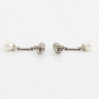 A pair of platinum pearl earings.