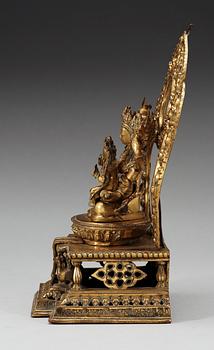 A large gilt bronze Nepal/Sino-Tibetan figure of Buddha, Qing dynasty, presumably Qianlong (1736-95). With an inscription around the base.