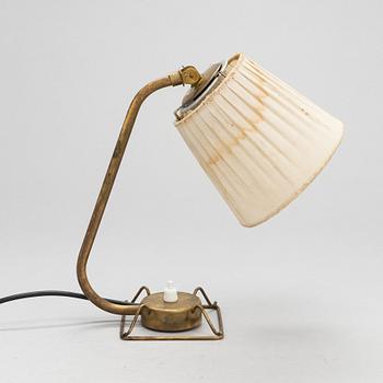 A mid-20th-century table lamp
/wall light for Idman.