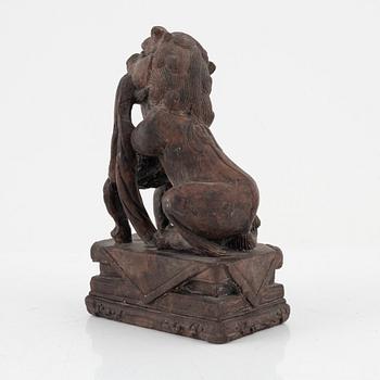 A stone sculpture of a mythical creature and four textile fragments, Qing dynasty.