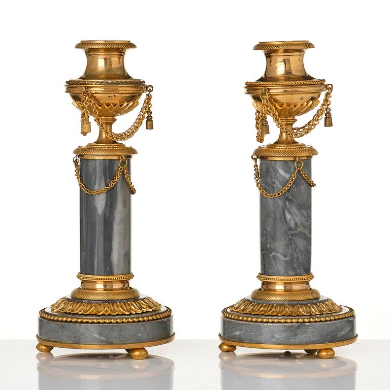 A pair of Louis XVI ormolu and Bleu turquin candlesticks.