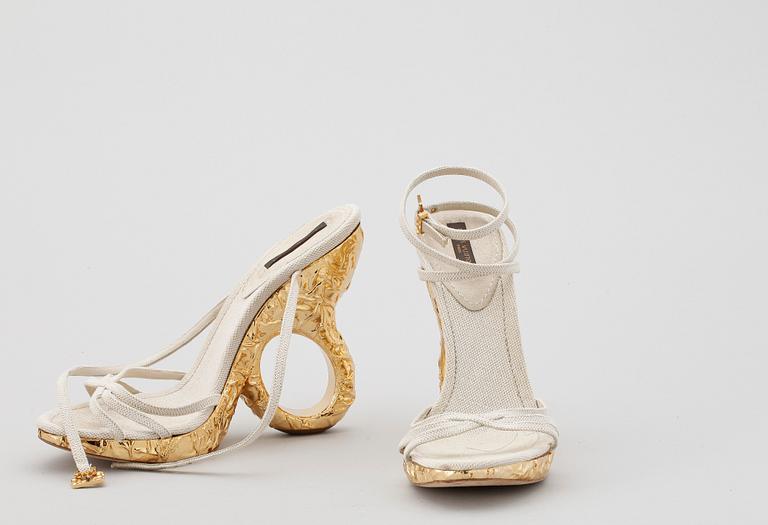 A pair of shoes by Louis Vuitton.