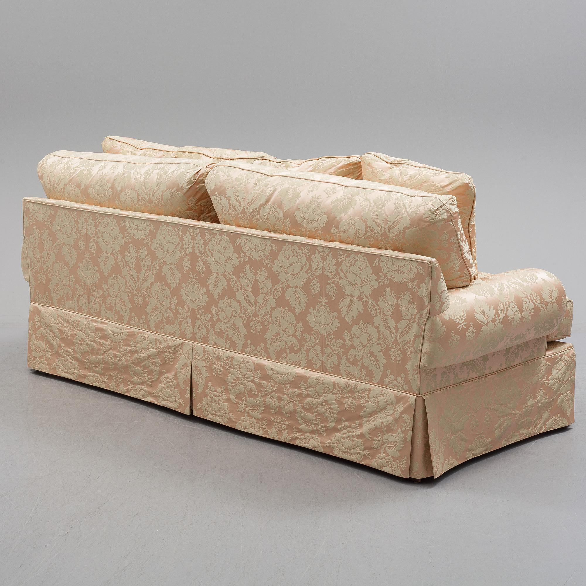 A sofa upholstered with silk damask.