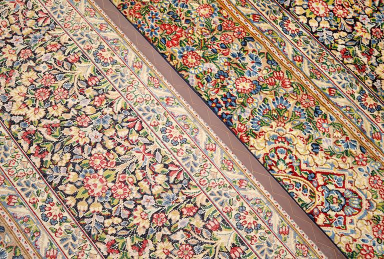 A Kirman Laver carpet, 'Millefleur', approx. 492 x 350 cm.