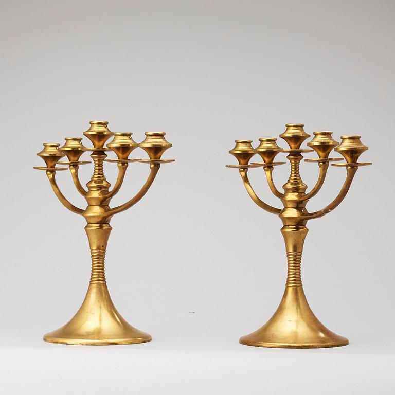A pair of brass candelabra attributed to Bruno Paul, Germany, early 20th Century.