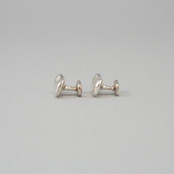 A pair of sterling cufflinks by Elsa Peretti for Tiffany & co.