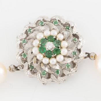 Pearl necklace, cultured pearls with a clasp in 18K white gold set with emeralds, diamonds, and pearls.