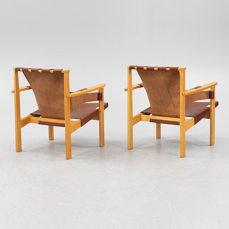 Carl-Axel Acking, a pair of oak and brown natural leather 'Trienna' chair, Nordiska Kompaniet, Sweden.