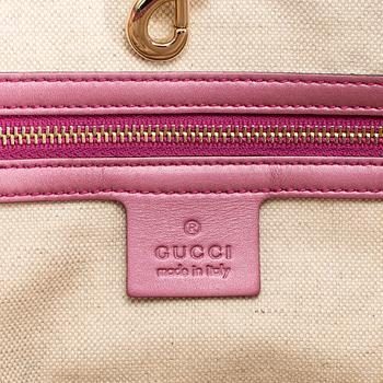 GUCCI, a monogram canvas and pink metallic leather handbag.