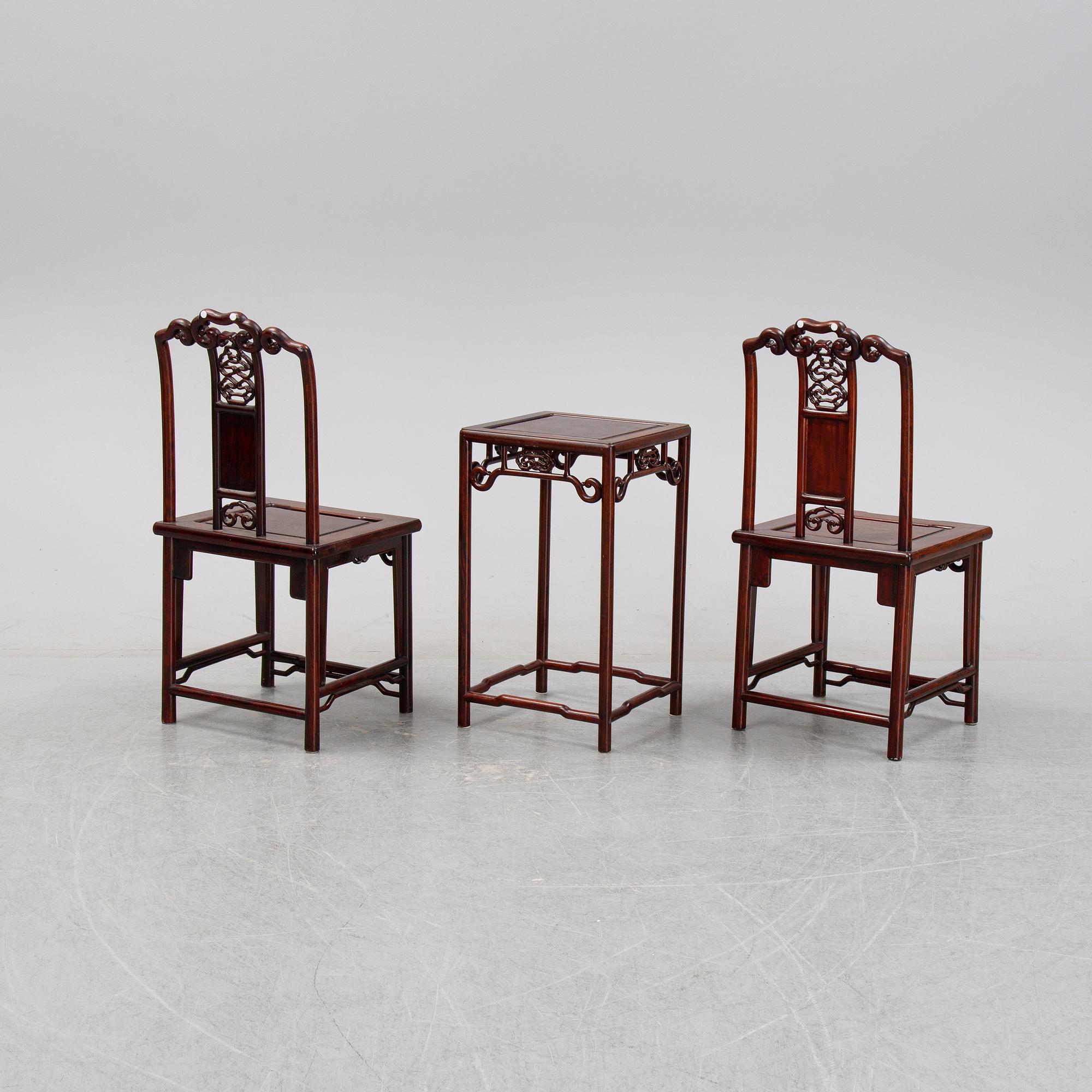 A pair of Chinese hardwood contemporary chairs and table.