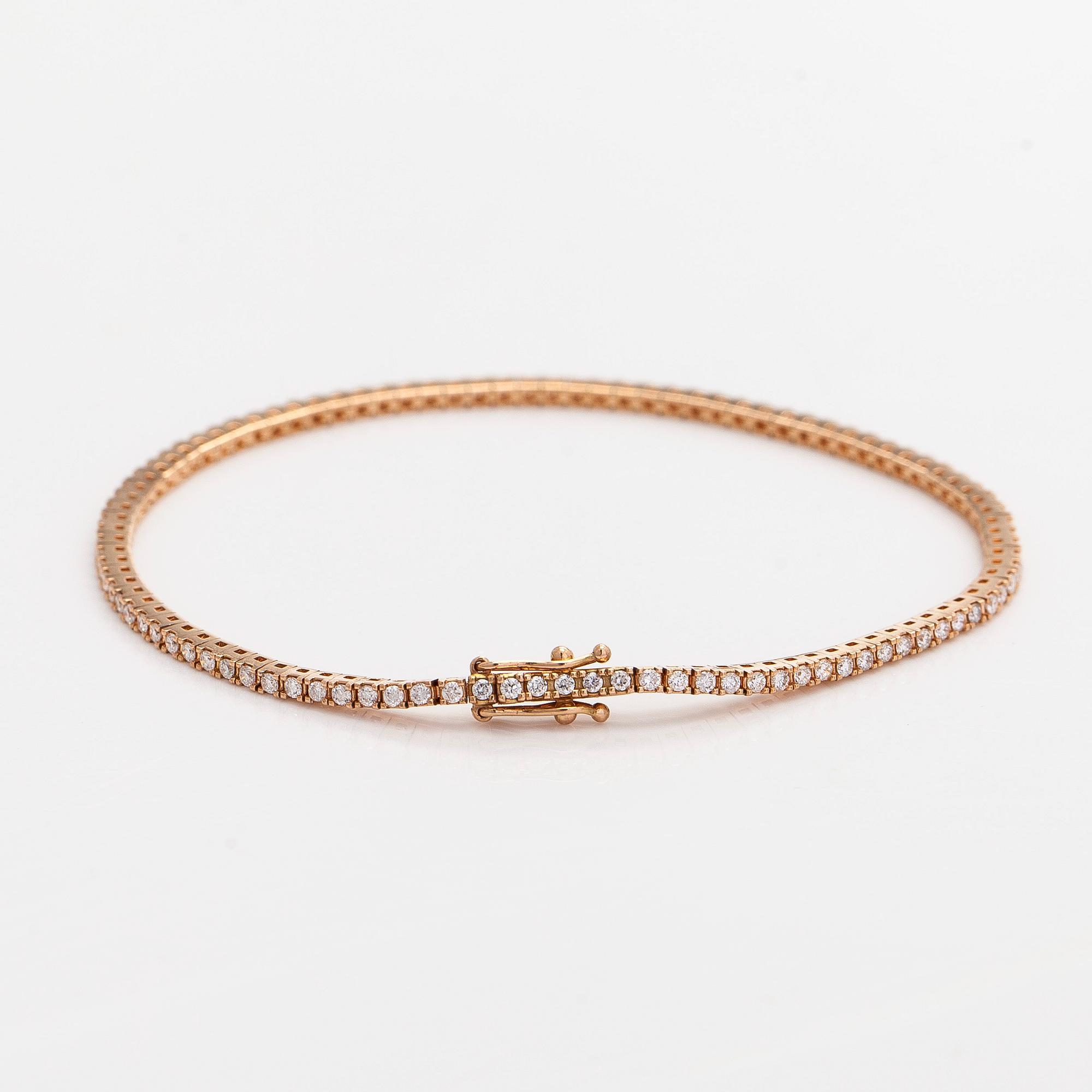 An 18K rose gold tennis bracelet with brilliant cut diamonds.