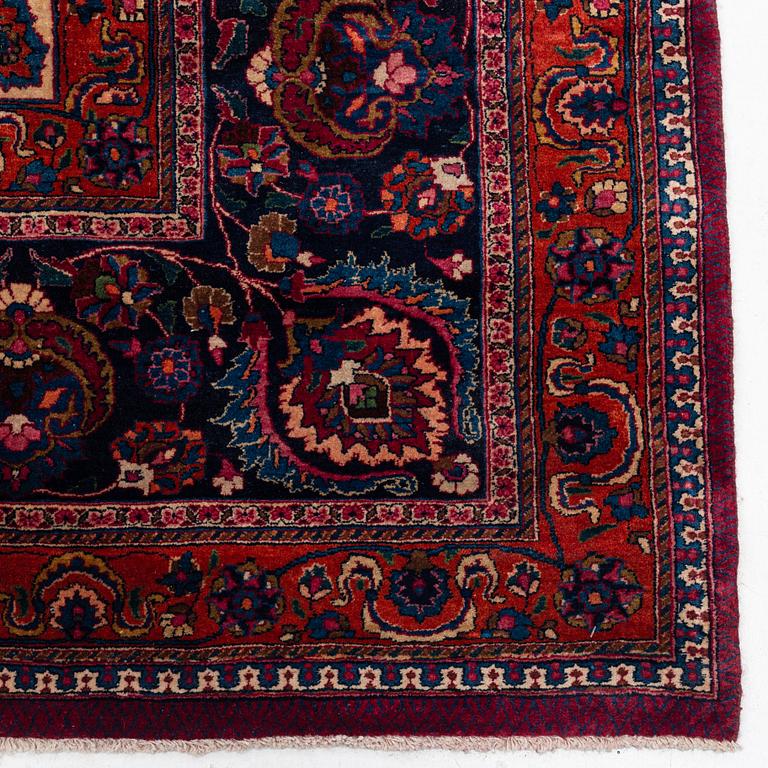 A Mashad carpet, signed Saber, c. 459 x 348 cm.