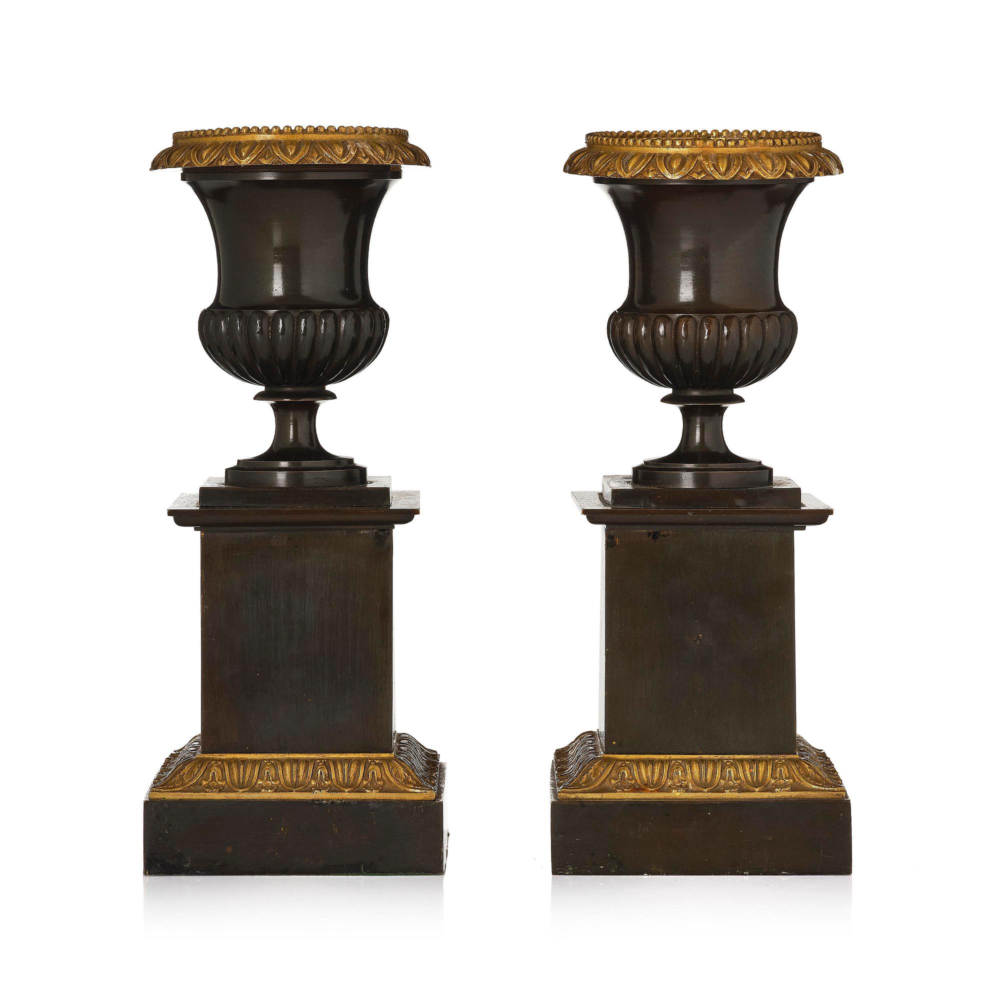 A pair of French Empire ormolu and patinated bronze urns, circa 1820.