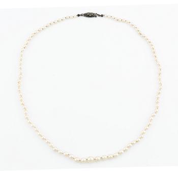 A cultured pearl necklace with a silver clasp.