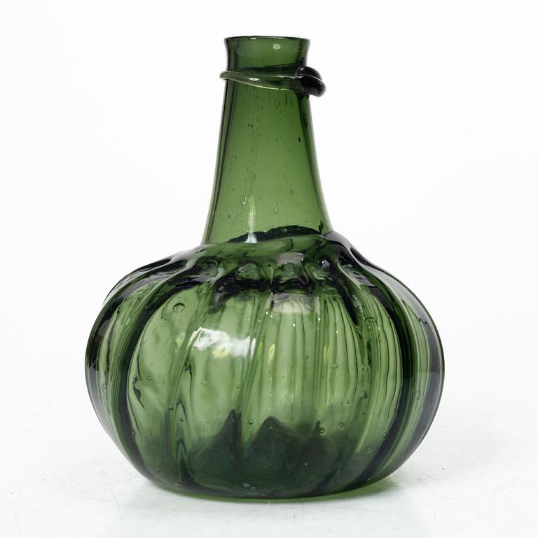 A green twisted glass bottle, 18th century.
