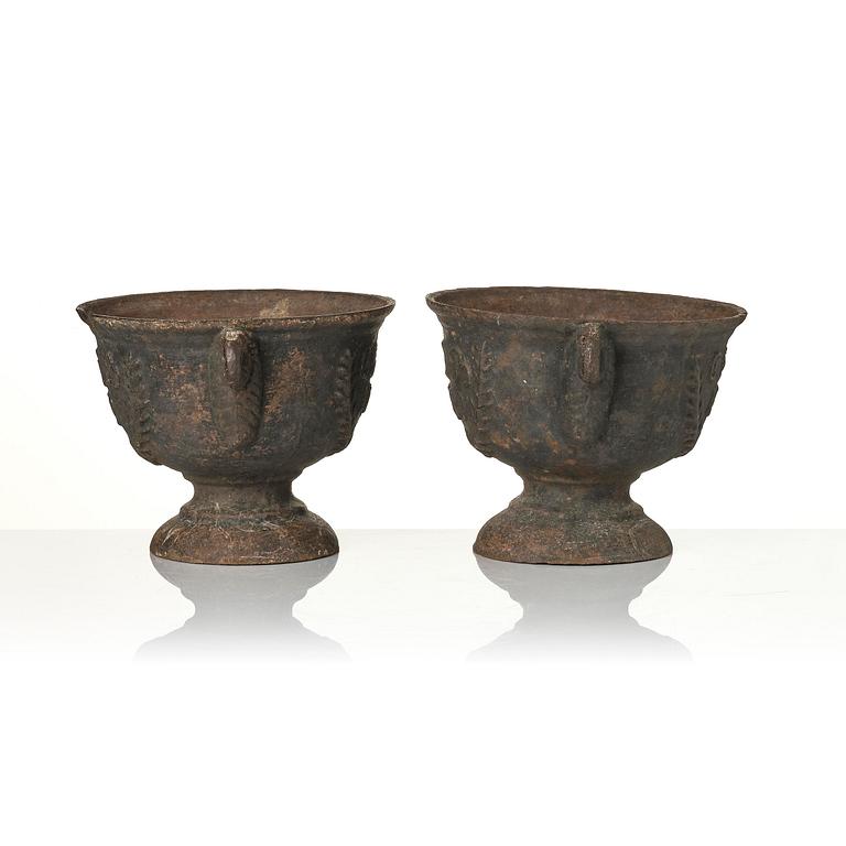 A pair of cast-iron garden urns, presumably from Näfveqvarns styckebruk, dated 1789.
