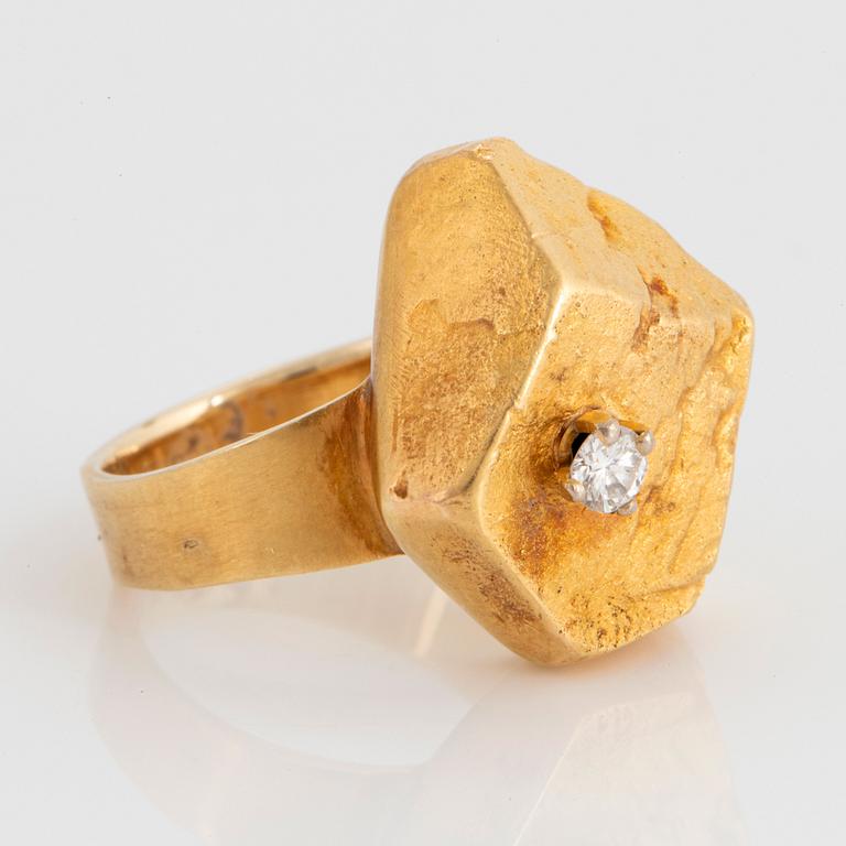 A 14K gold ring set with a round brillant-cut diamonds, made by a part of a Lapponia bracelet.