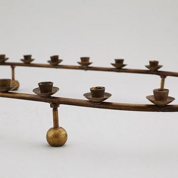A mid 20th Century brass candle ring.