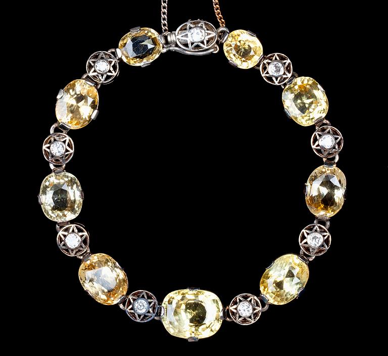 ARMBAND, gula fasettslipade safirer med gammalslipade diamanter, tot. ca 0.45 ct. Sekelskifte 1900.