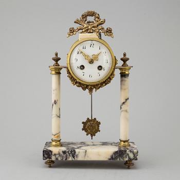 A marble and brass pendulum clock, first half of the 20th century.