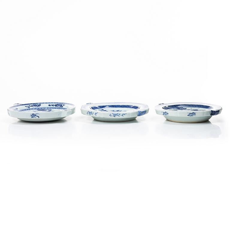 A group of three Chinese blue and white porcelain hot water dishes, Qing dynasty, 18/19th century.