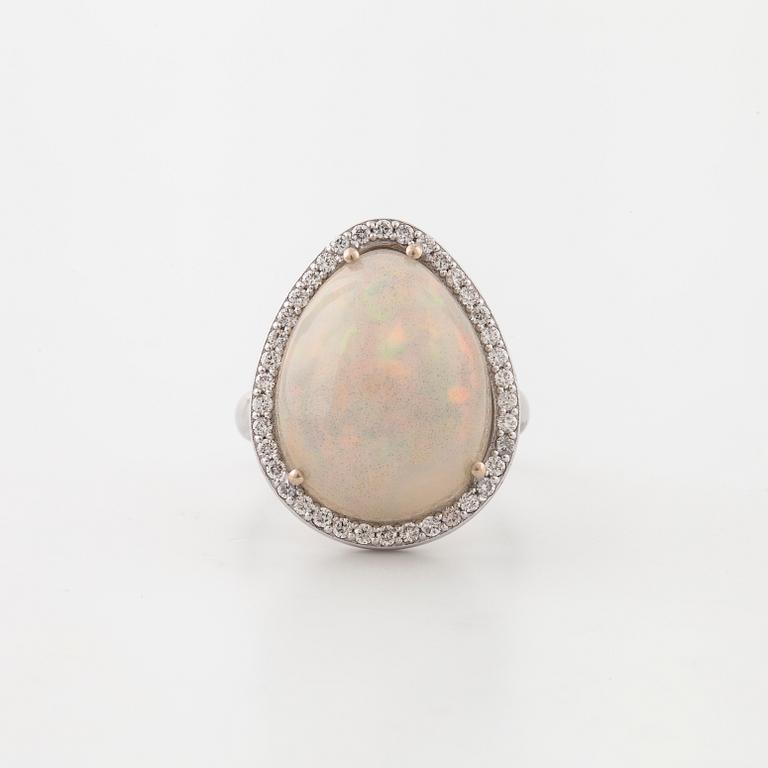 A cabochon cut white opal and a brilliant cut diamond ring.