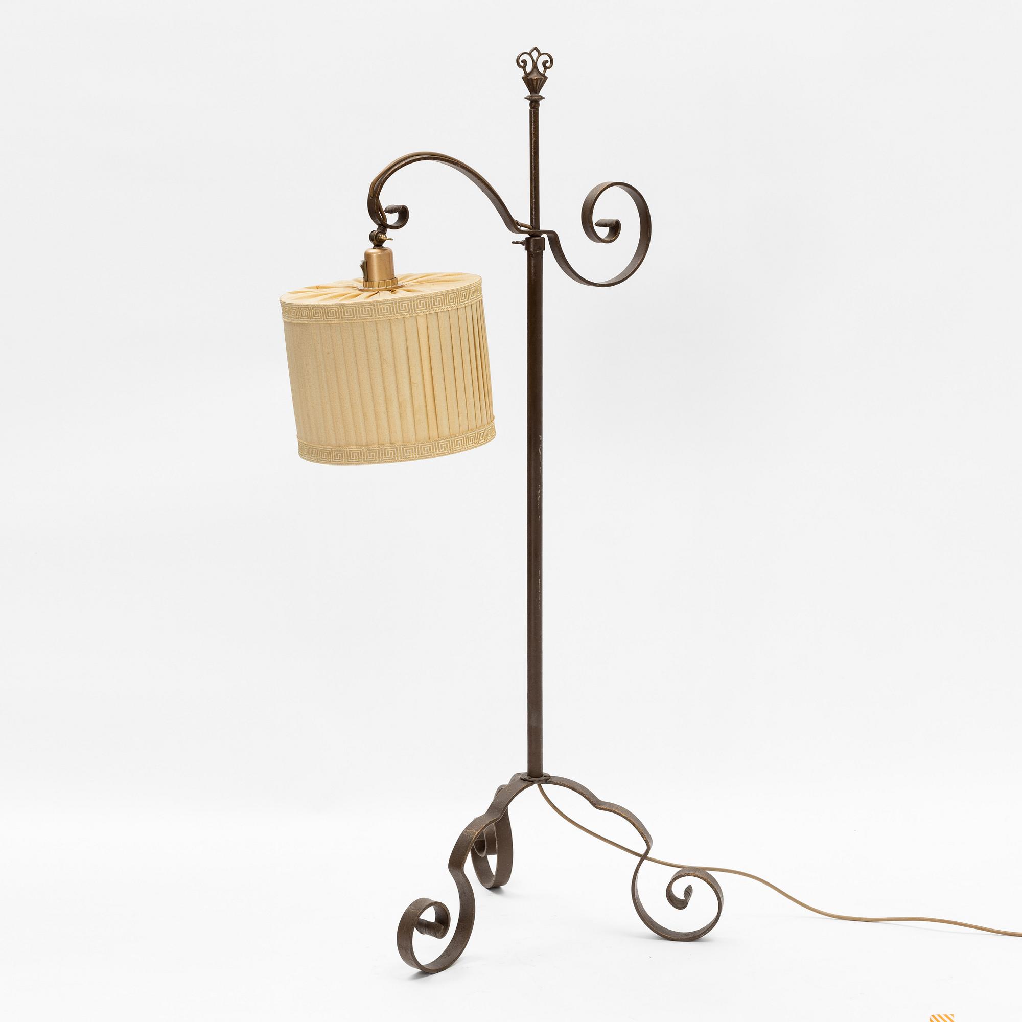 An iron floor lamp, early 20th Century.