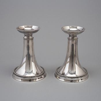 A pair of silver candlesticks by GAB, dated 1953.