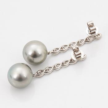 A pair of 18K white gold earrings set with Tahitian cultured pearls and round brilliant-cut diamonds.