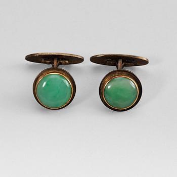 35. A pair of Chinese jadeite cufflinks mounted in partially goldplated silver, early 20th century.