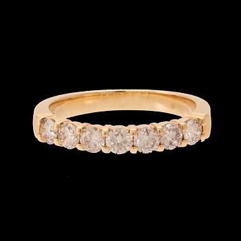 An 18K gold half-eternity ring set with round brilliant-cut diamonds.