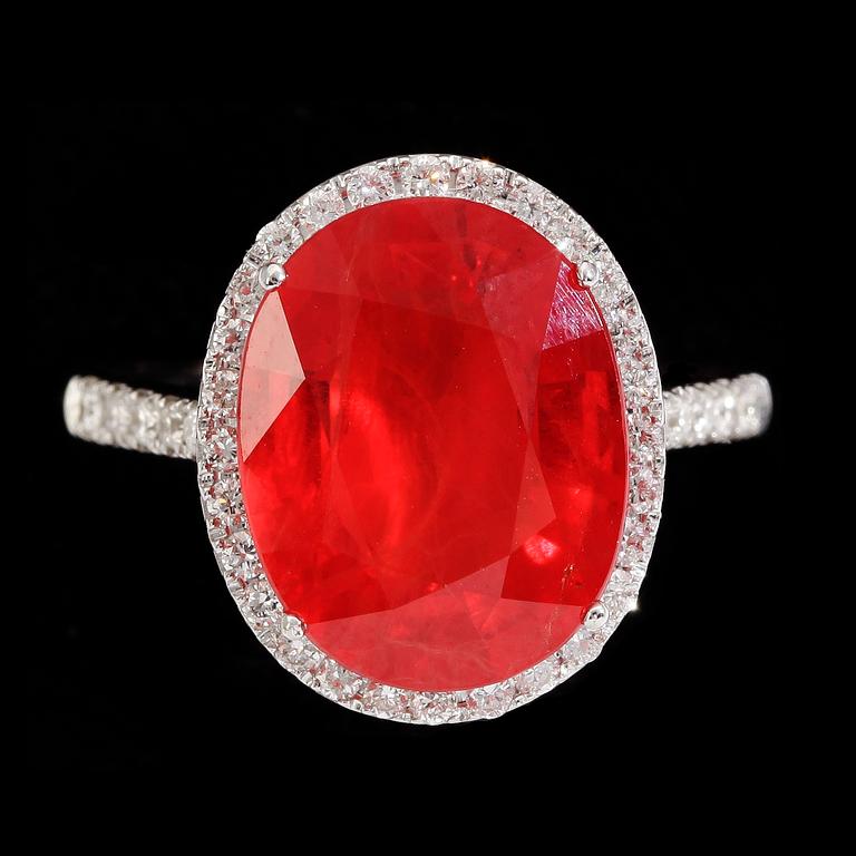 An orange sapphire, 6.30 ct, and brilliant cut diamond ring.