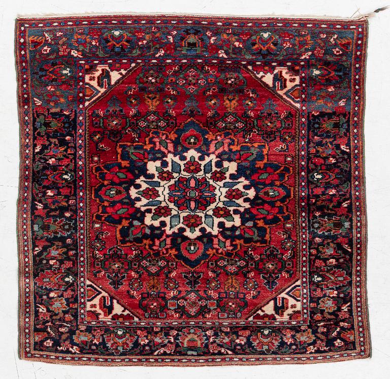 An Old Northwest Persian rug, c. 127 x 125 cm.
