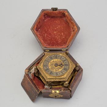 A gilded brass baroque travel clock from around 1700, with original case.