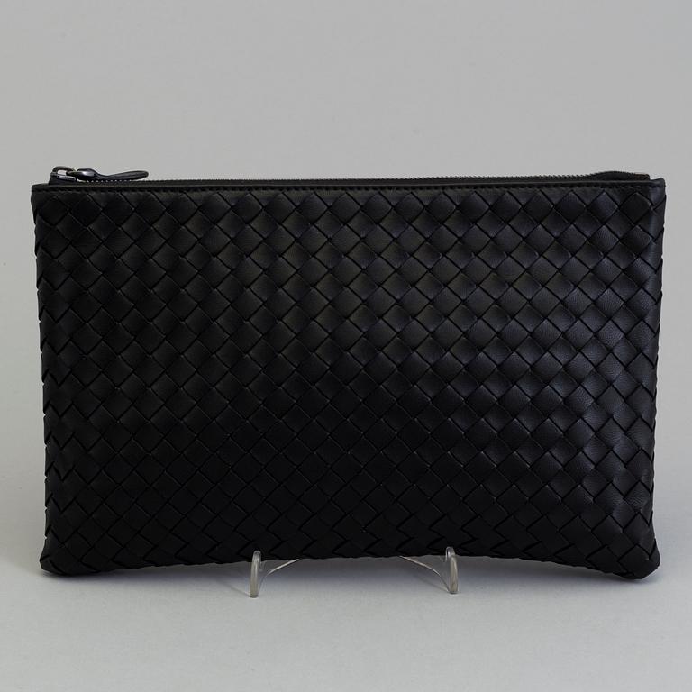 A black leather clutch by Bottega veneta.