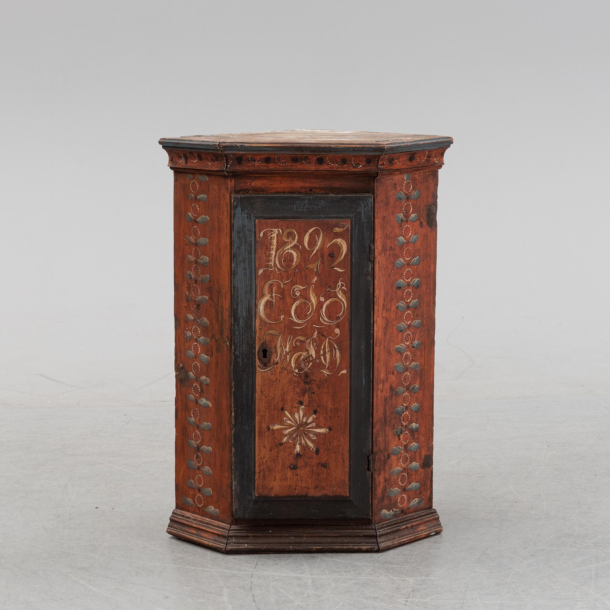 A Swedish painted corner cabinet, dated 1825.