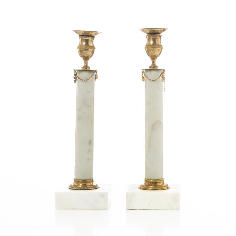 A pair of late Gustavian gilt brass and marble candlesticks, circa 1800.