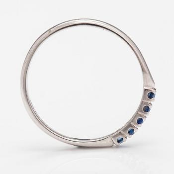 A 14K white gold ring with sapphires.