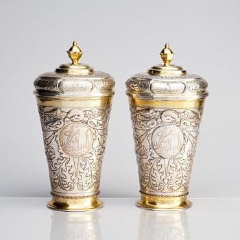 A pair of Russian Baroque parcel-gilt silver cups and covers, mark of Nikifor Timofeev, Moscow 1729.