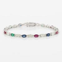 Bracelet 18K white gold set with faceted rubies, emeralds, sapphires, and round brilliant-cut diamonds.