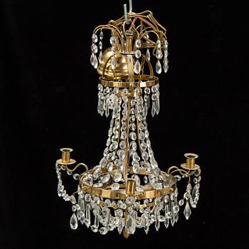 A small Swedish 20th century empire style chandelier for three candles.