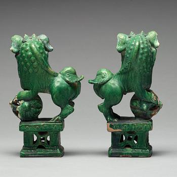 A pair of green glazed buddhist lions, Ming dynasty (1368-1644).