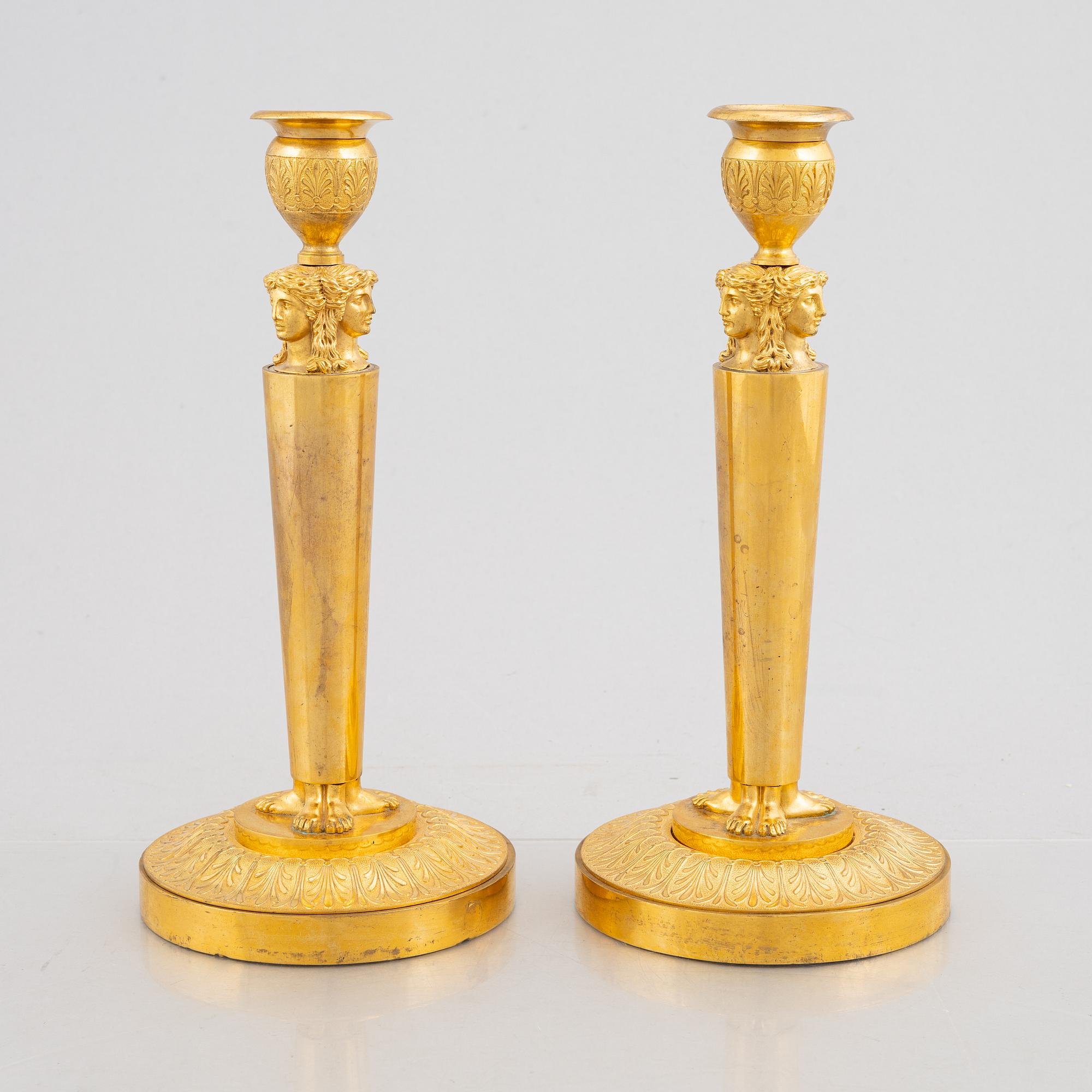 A pair of gilt-bronze Emnpire style candlesticks in the manner of Claude Galle, 19th century.