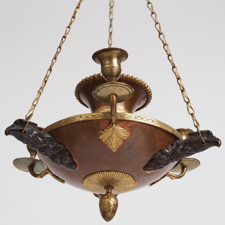 A Swedish patinated bronze and copper three-light chandelier, early 19th century.