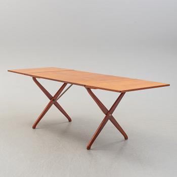 A teak veneer and stained beech dining table, mid 20th Century.