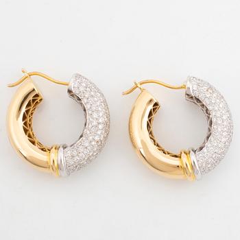 Gold and brilliant-cut diamond hoop earrings.