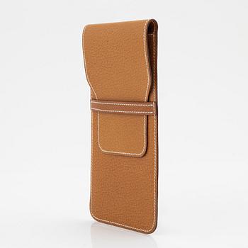 Hermès, a brown leather case for sunglasses.