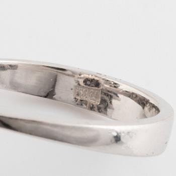 An 18K white gold, navette sapphire and baguette- and round brilliant cut diamond ring.