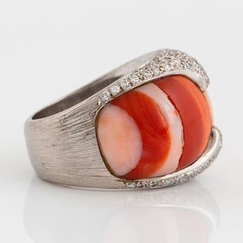 A Paul Binder ring in 18K white gold set with coral and round brillliant-cut diamonds.